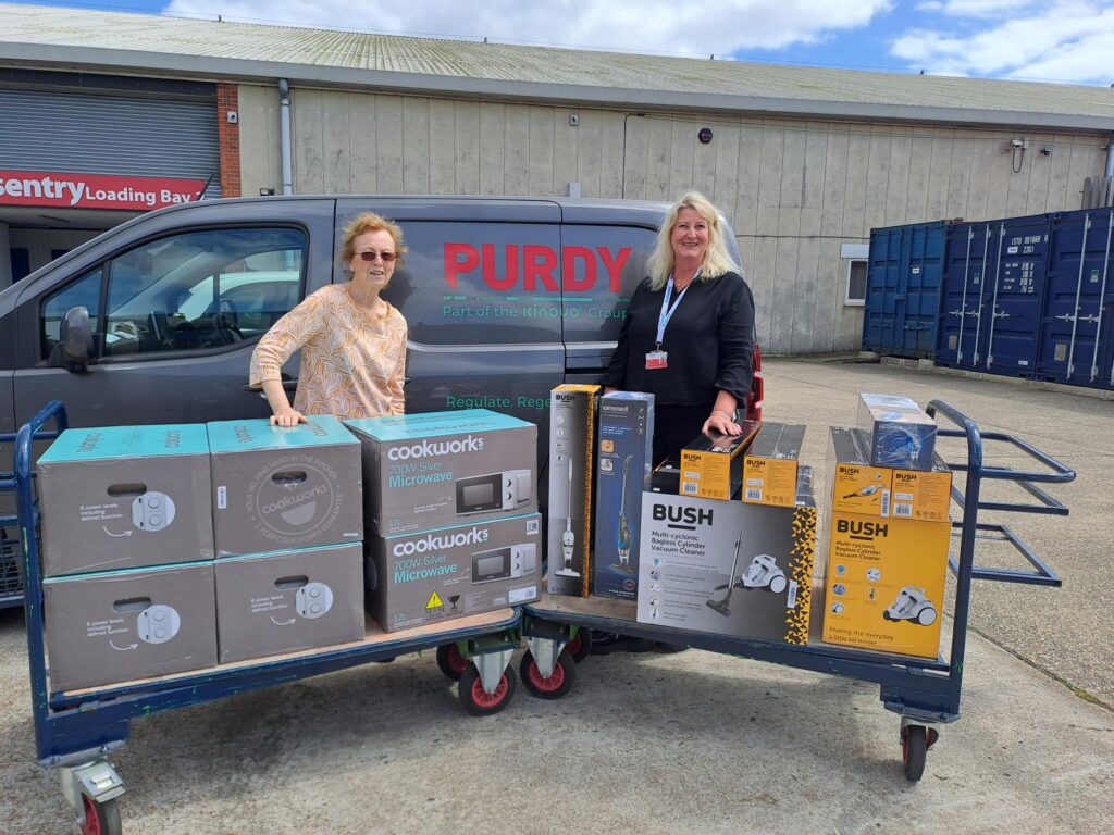Therese Brook and supplier Purdy with donations of microwaves and kettles ready to be given to families in need.