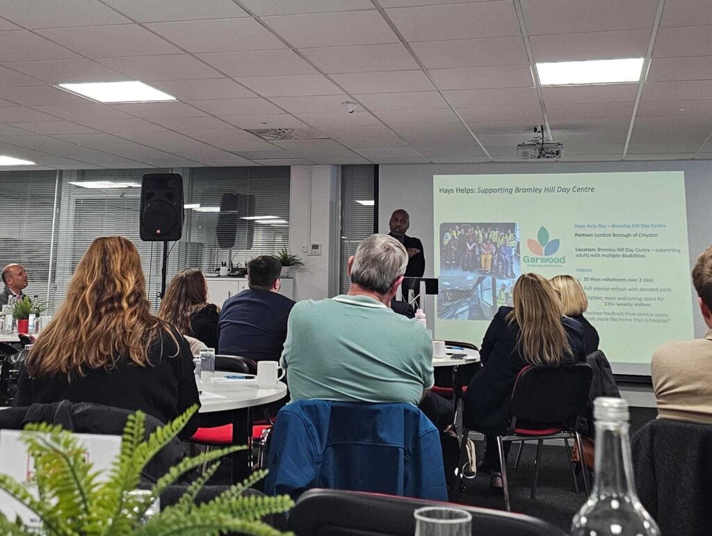 Photo of attendees gathered for the Croydon Council launch event, facing a presenter and screen at the front of the room.